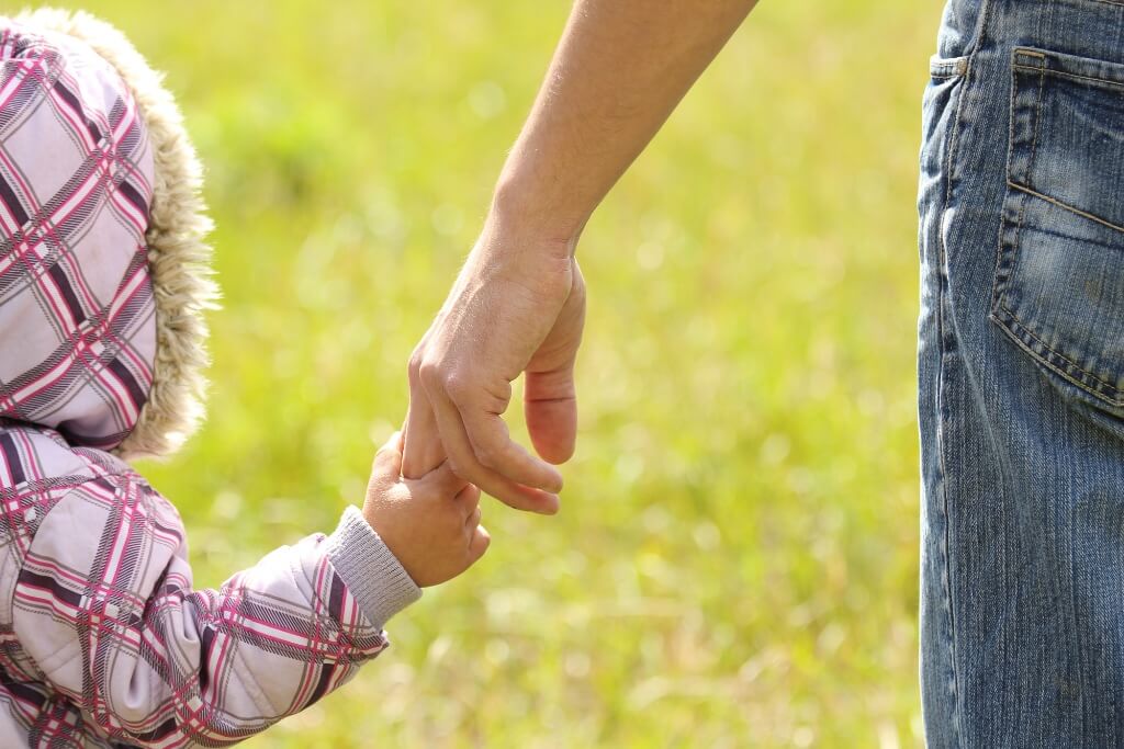Child Holding A Finger Of The Dad