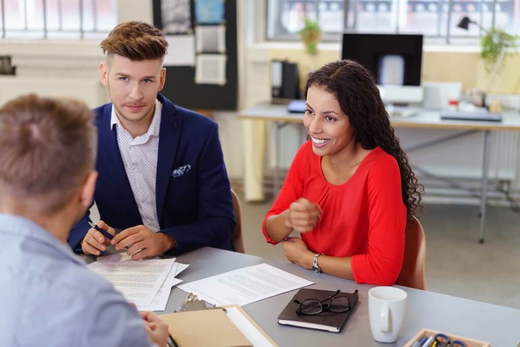 Lawyer Discussing With Her Smiling Client